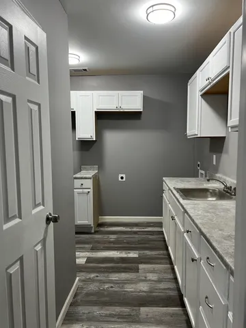 a bathroom with a sink a toilet and mirror
