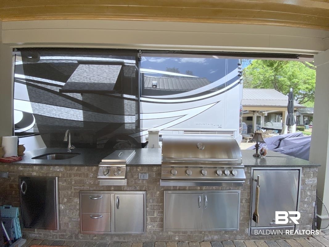 28888 Canal Road, Unit 32 Orange Beach, AL 36561 - Photo 17 of 29 View of patio featuring a sink and an outdoor kitchen