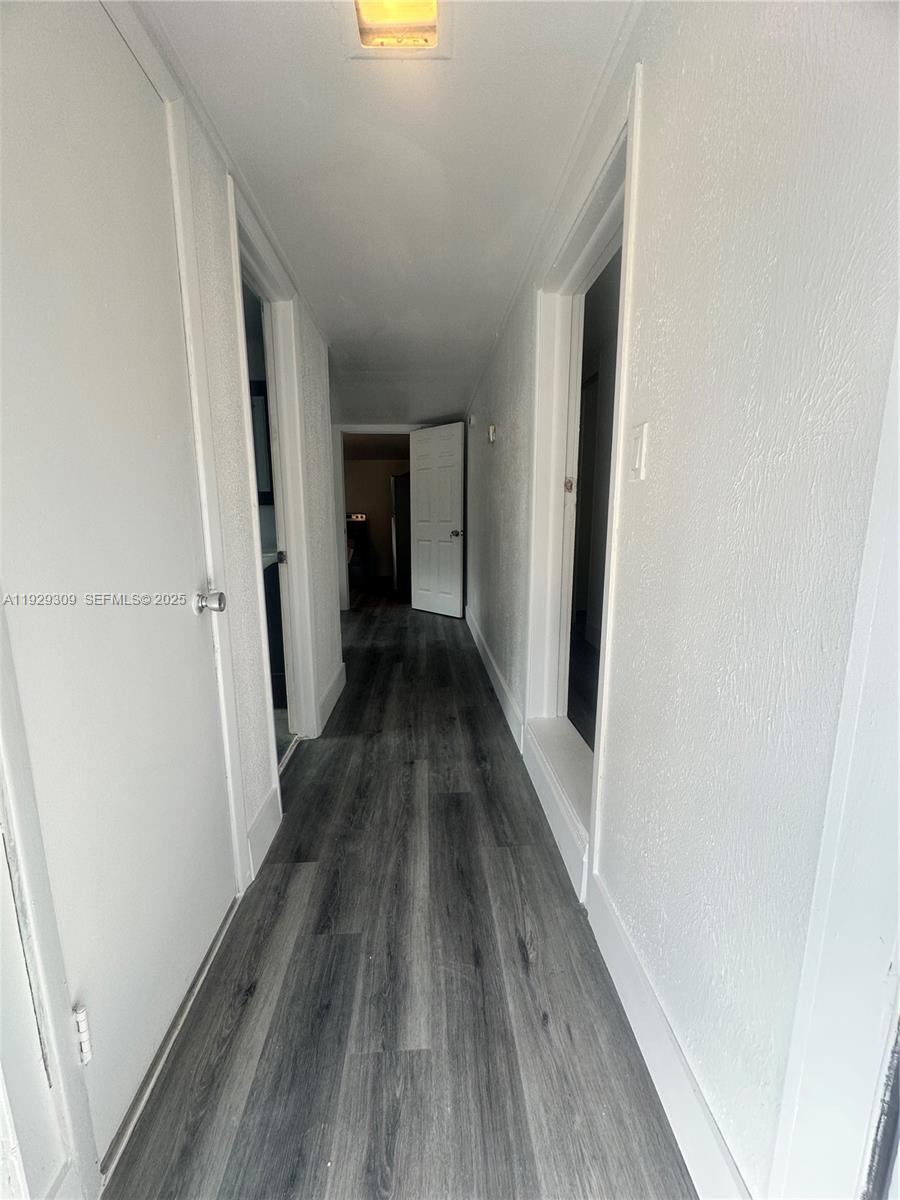 4762 Canal Road, Unit A1 West Palm Beach, FL 33415 - Photo 5 of 10 a view of a hallway with wooden floor and staircase