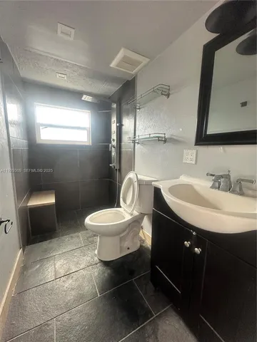 a bathroom with a sink toilet and a mirror