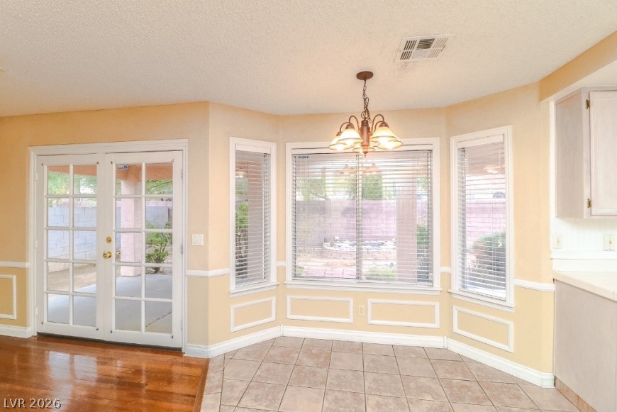 1429 Hawkwood Road Henderson, NV 89014 - Photo 14 of 53 Multi-pane glass doors and a bay window illuminate this versatile dining area.