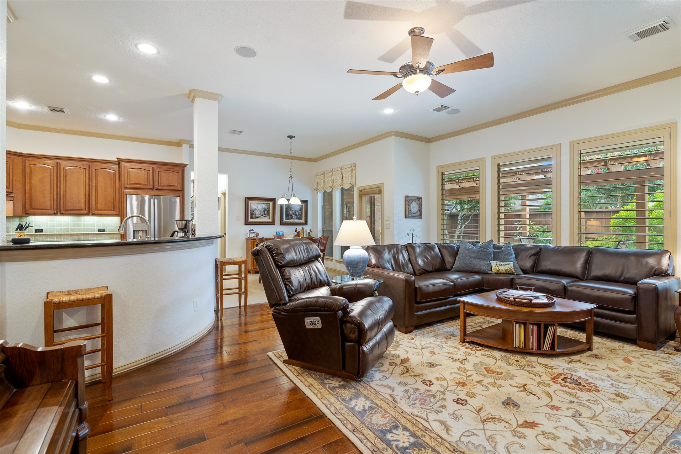 19507 Remington Manor Street Spring, TX 77379 - Photo 6 of 33 View of the family room and kitchen showcasing the open concept living and large curved breakfast bar for additional seating.