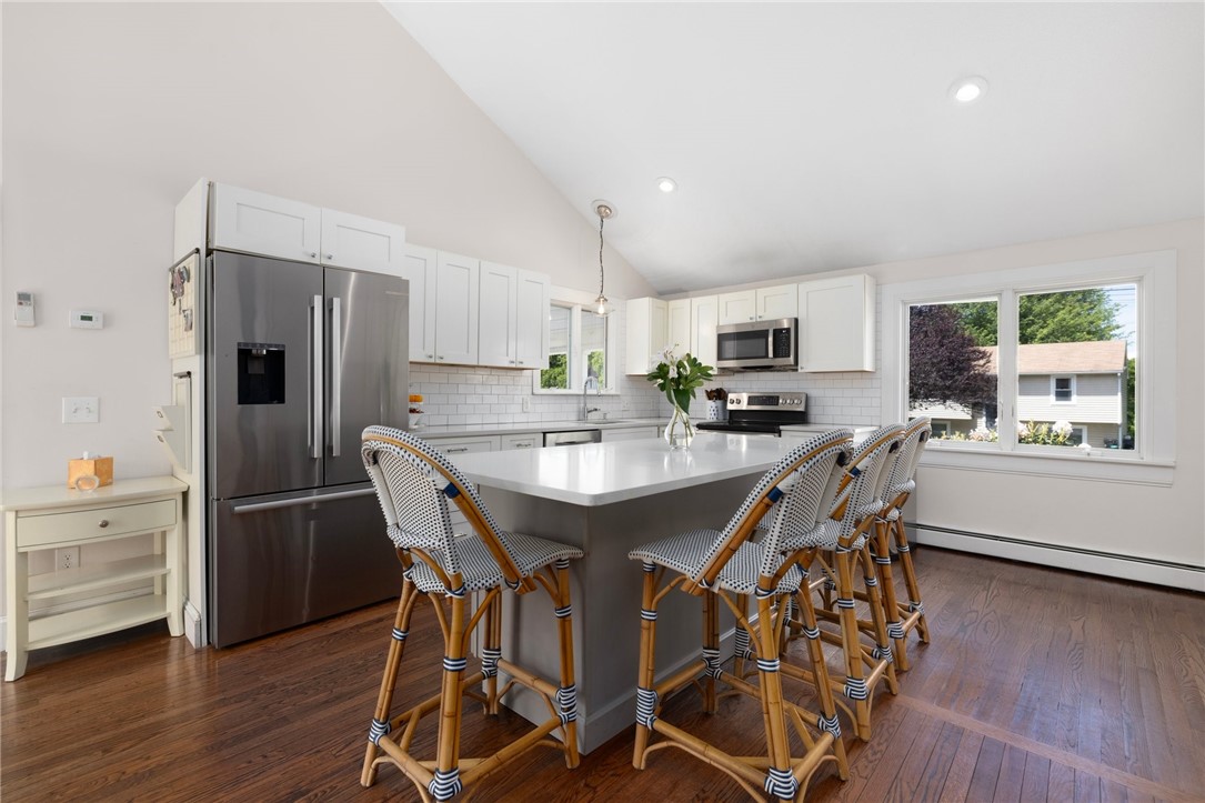 8 Schoolhouse Road Narragansett, RI 02882 - Photo 17 of 41 Stainless steel appliances and sleek quartz countertops. Dishwasher and refrigerator are Bosch. Stove and microwave are GE.