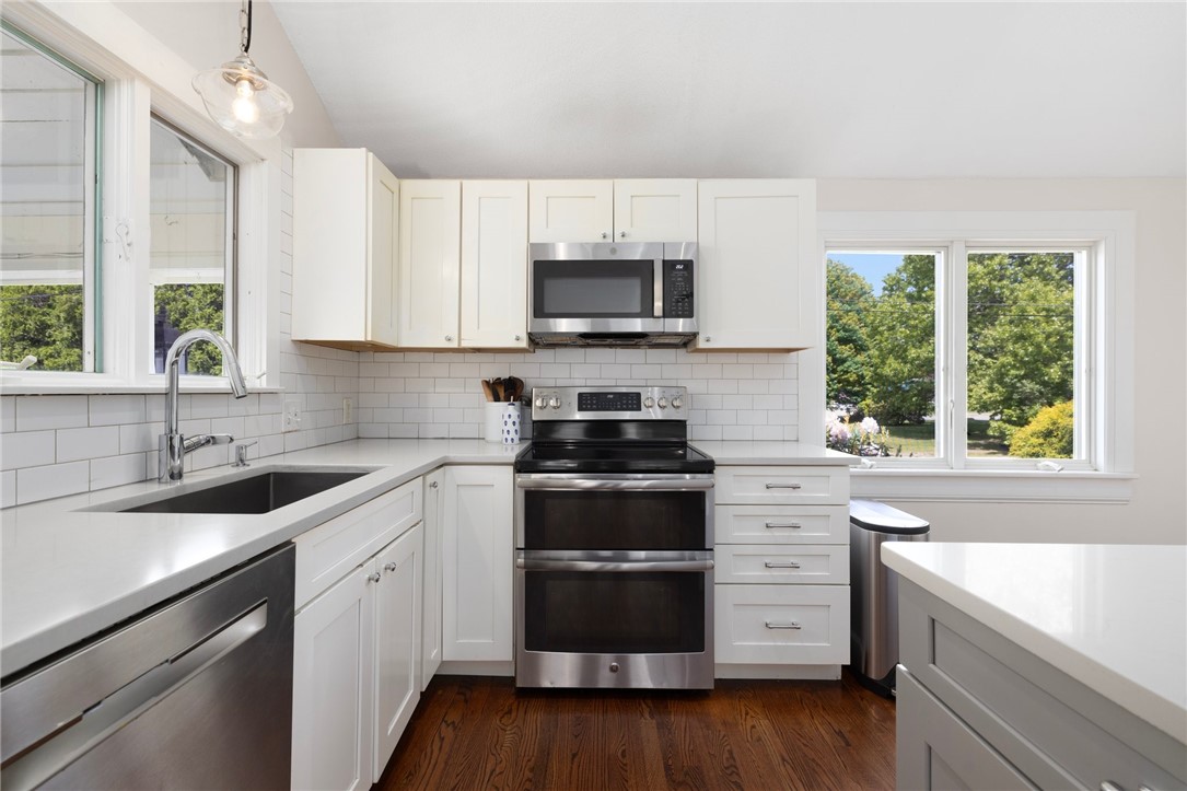8 Schoolhouse Road Narragansett, RI 02882 - Photo 18 of 41 Subway tile backsplash, quartz countertops and an easy feeling flow for cooking and entertaining. The cabinets boast hardware from Restoration Hardware.