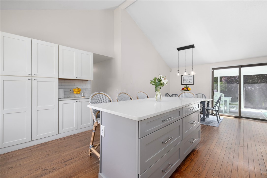 8 Schoolhouse Road Narragansett, RI 02882 - Photo 19 of 41 Love this shot as it showcases the extra cabinet storage on this side of the kitchen. The opening mid-photo is the hallway to 2 bedrooms, full bath and office.