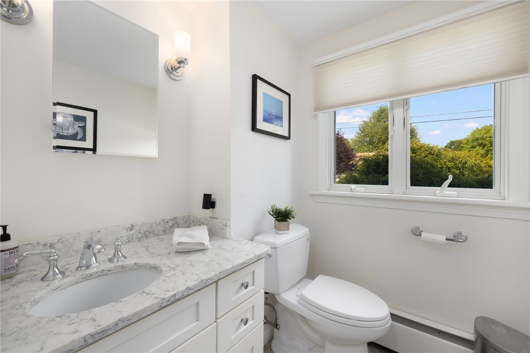 8 Schoolhouse Road Narragansett, RI 02882 - Photo 24 of 41 First floor full bath redone in 2016 with quartz countertop, tile floor, new window, new Toto toilet and a feeling of elegance.