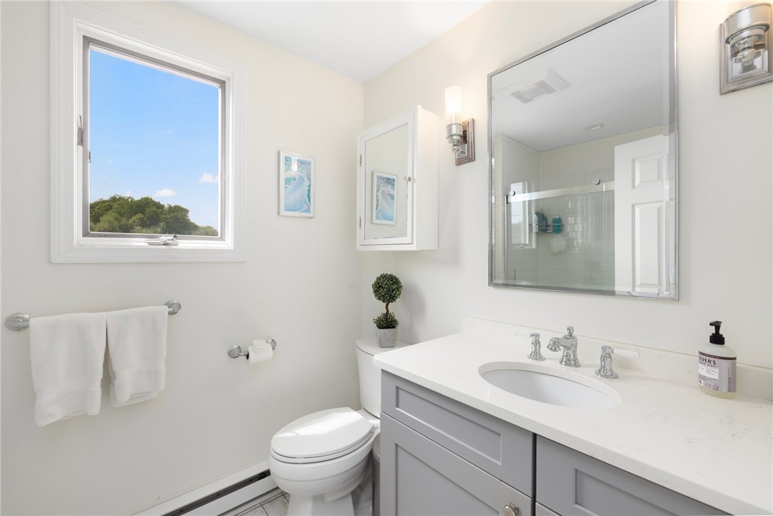 8 Schoolhouse Road Narragansett, RI 02882 - Photo 32 of 41 Quartz countertop, tile floor, Kohler toilet and a window with a view! Plumbing fixtures in home are high end Hansgrohe and Kohler.