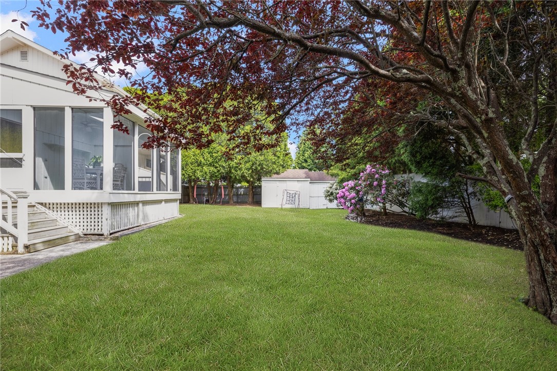 8 Schoolhouse Road Narragansett, RI 02882 - Photo 39 of 41 Gorgeous back yard showing double sheds in rear and views of the screened porch overlooking the greenery.