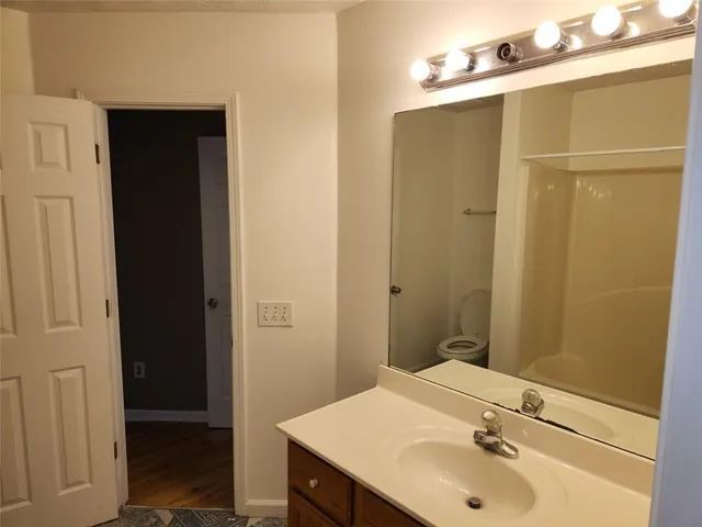 a bathroom with a shower and a toilet