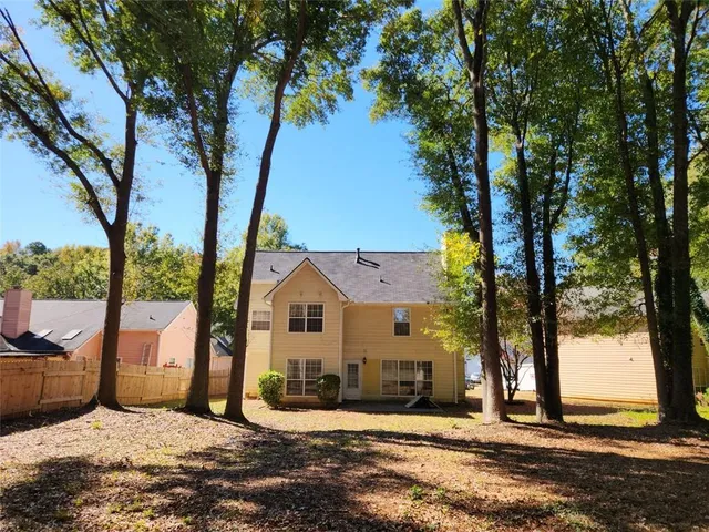 a view of a house with a tree in the background