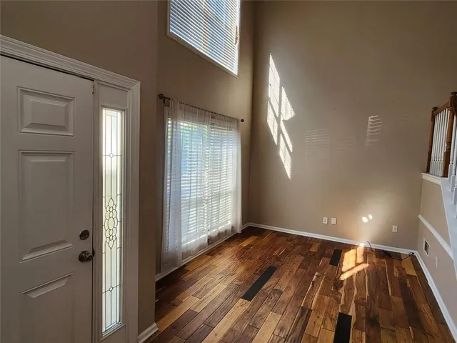 a view of staircase with railing and white walls