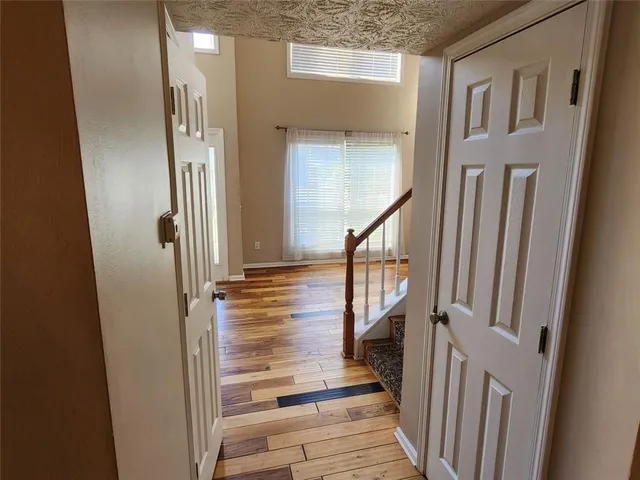 a view of an entryway with wooden floor