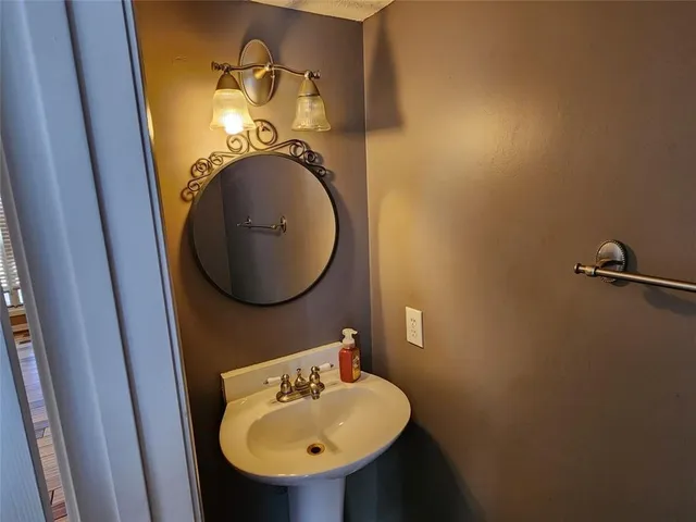 a spacious bathroom with a granite countertop sink and a bathtub