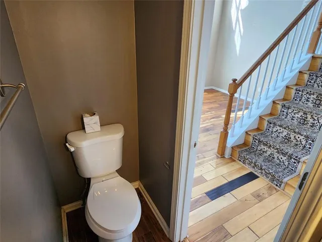 a kitchen with granite countertop a sink cabinets and wooden floor