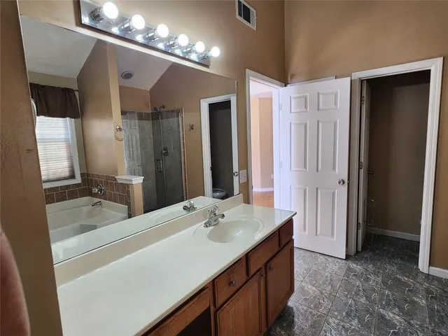 a bathroom with a double vanity sink and a mirror