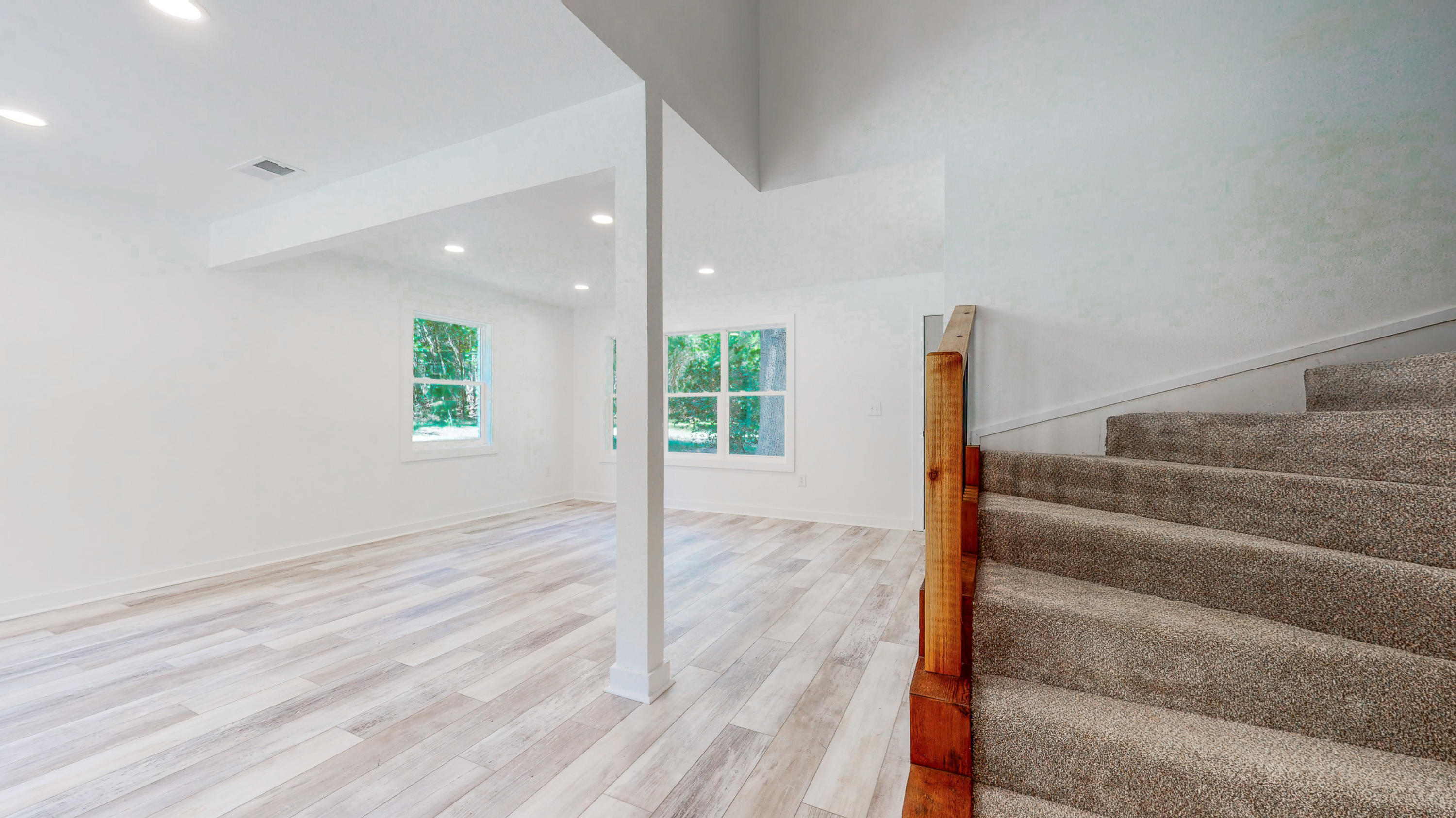 2522 Kingston Road Crestview, FL 32536 - Photo 17 of 43 a view of an empty room with wooden floor and a window