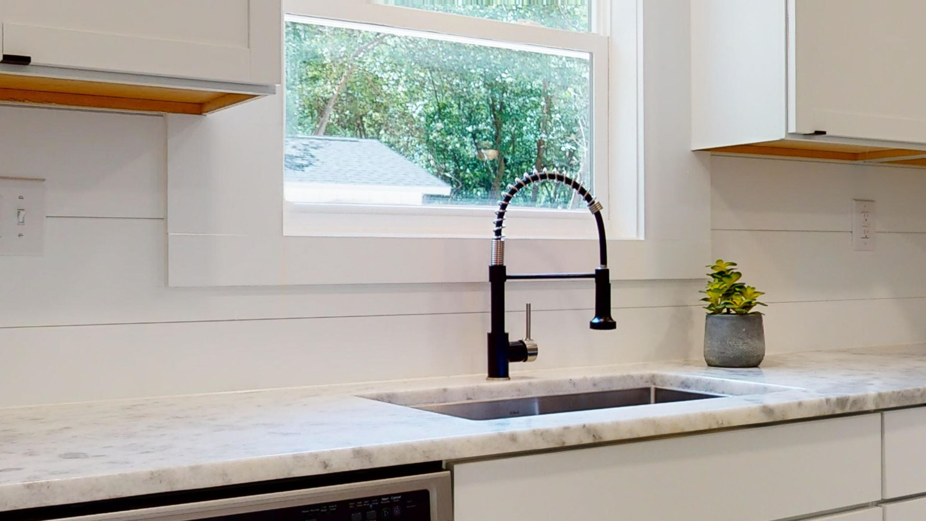 2522 Kingston Road Crestview, FL 32536 - Photo 5 of 43 a kitchen with a sink and a potted plant