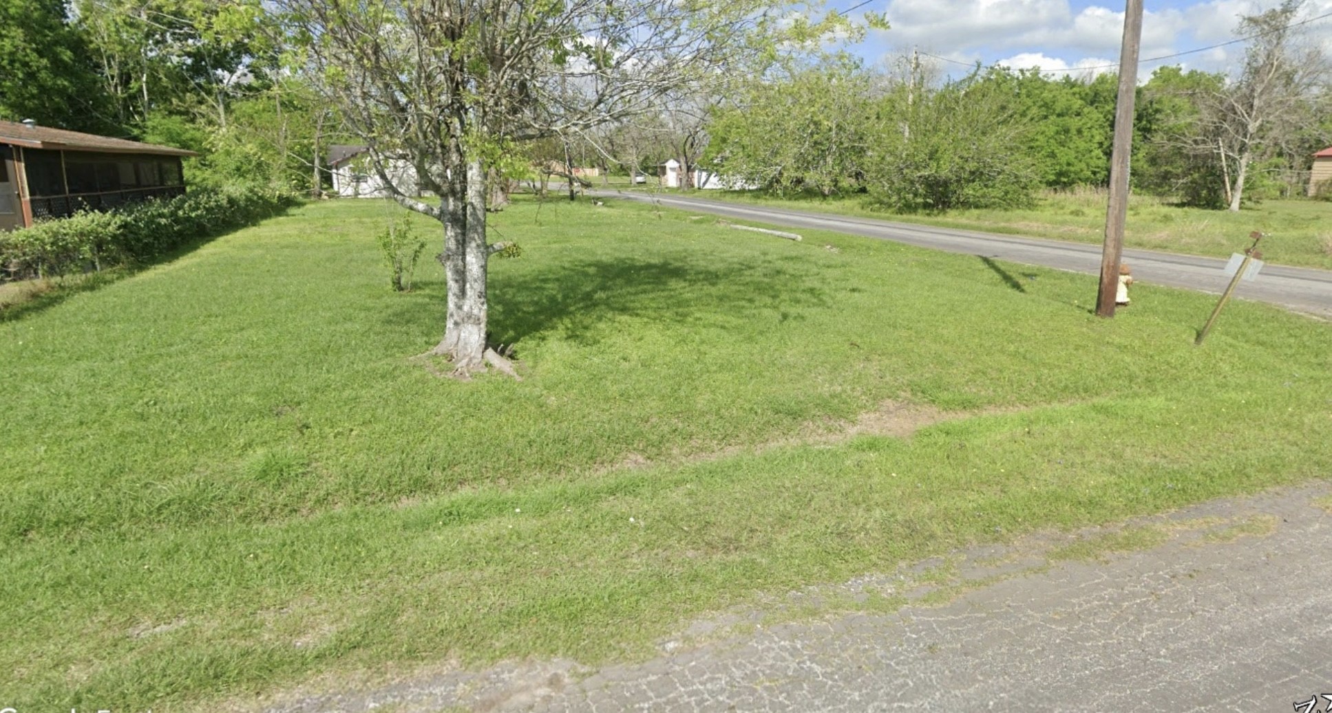 1416 Rugeley Street Bay City, TX 77414 - Photo 7 of 8 a view of a green field with a tree