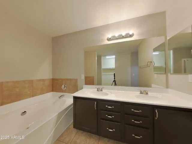 an empty room with a ceiling fan and a fan