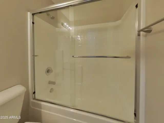 a bathroom with a toilet a sink a mirror and vanity