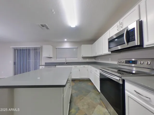 a view of kitchen with refrigerator sink and outdoor