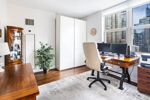 a workspace room with furniture and wooden floor