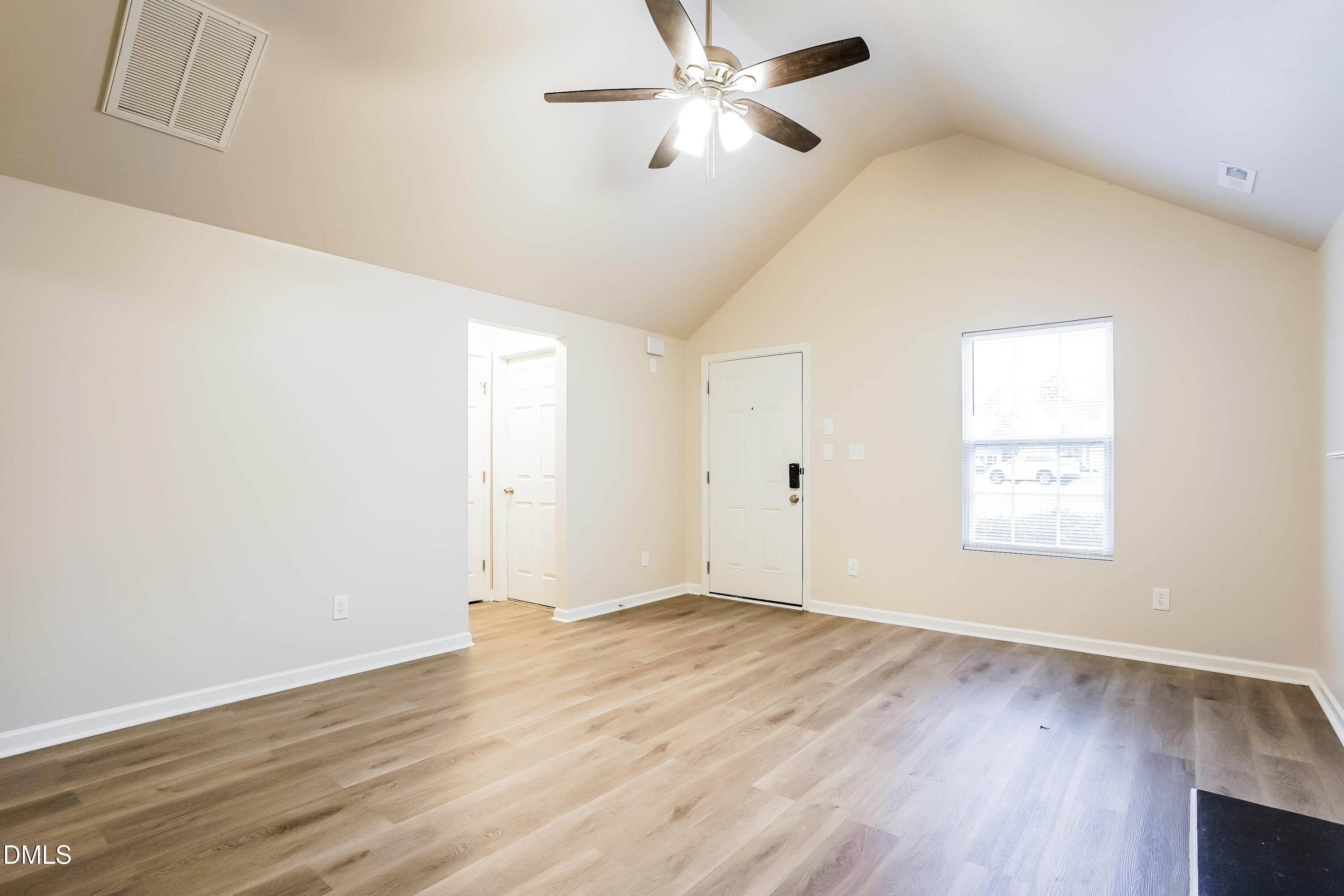 3405 Mogollon Court Raleigh, NC 27610 - Photo 2 of 16 a view of an empty room with wooden floor and a window