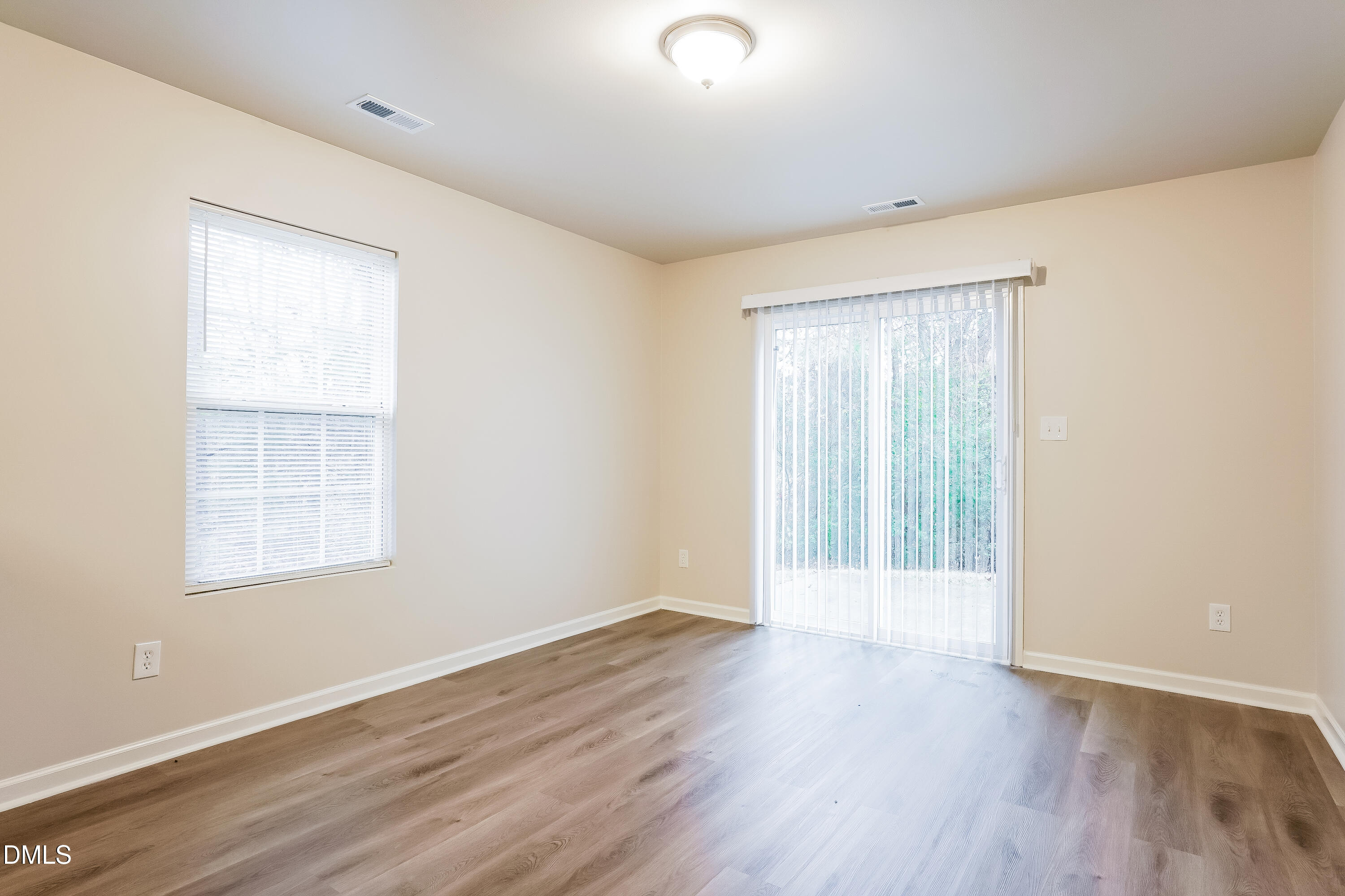 3405 Mogollon Court Raleigh, NC 27610 - Photo 4 of 16 an empty room with wooden floor and windows