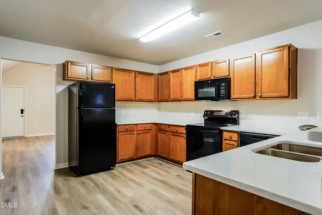 a kitchen with a refrigerator stove and sink