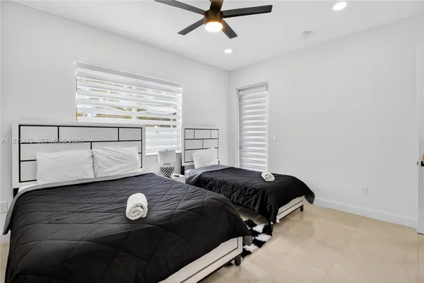 a bedroom with double bed and a window