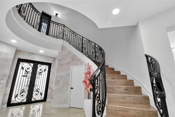 a view of entryway and hall with wooden floor