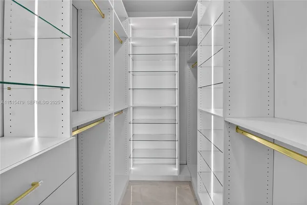 a view of walk in closet with empty racks