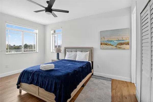 a bedroom with a bed lamp and window