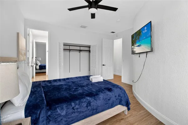 a bedroom with a bed and a chandelier