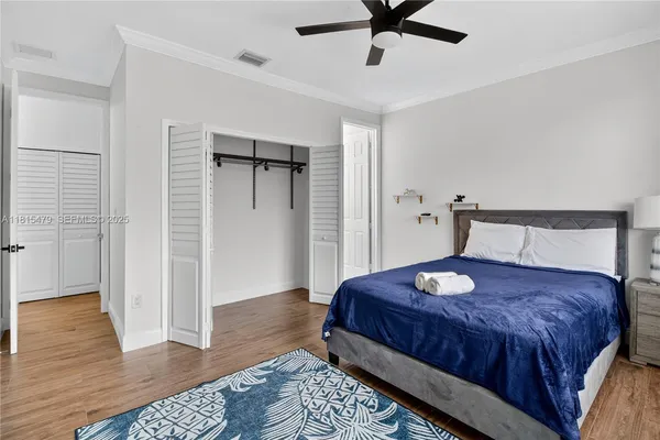 a bedroom with a bed and wooden floor