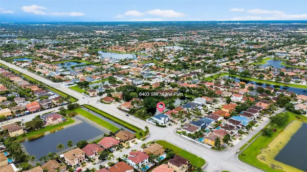 an aerial view of residential houses with outdoor space