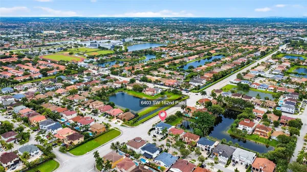 an aerial view of residential houses with outdoor space