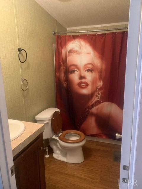 1730 Hermon Road Saxe, VA 23967 - Photo 11 of 23 a white toilet sitting next to a bathroom sink