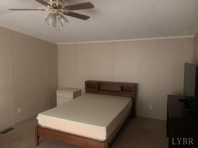 1730 Hermon Road Saxe, VA 23967 - Photo 18 of 23 a bedroom with a bed and a flat tv screen on the wall