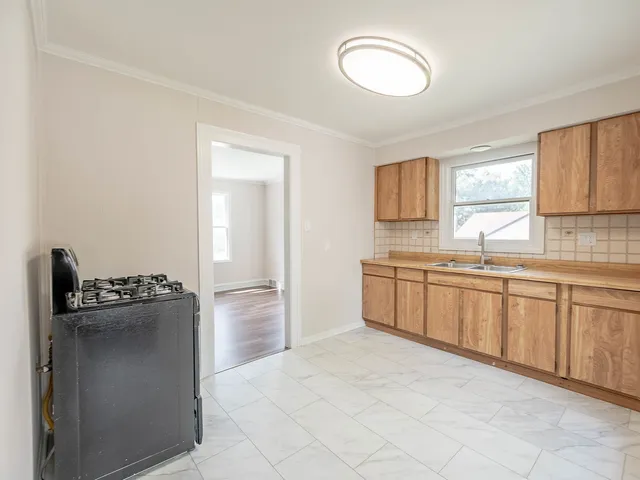 a kitchen with granite countertop a refrigerator and a sink