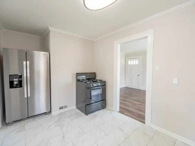 a kitchen with a refrigerator and a stove