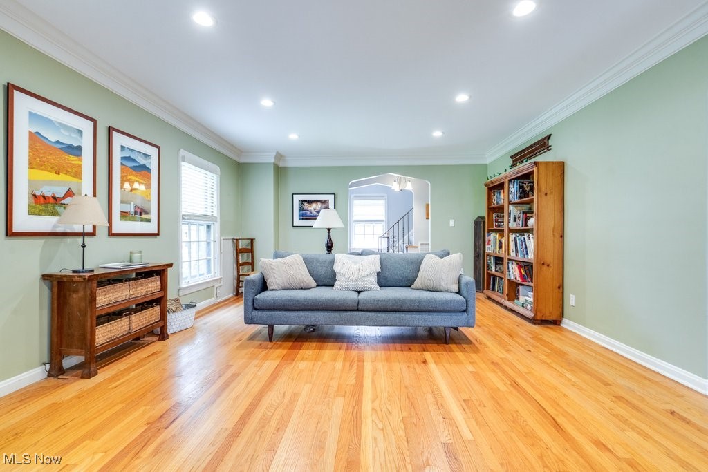 2500 Eaton Road Cleveland, OH 44118 - Photo 14 of 50 Living area featuring plenty of natural light, arched walkways, wood finished floors, crown molding, and baseboards