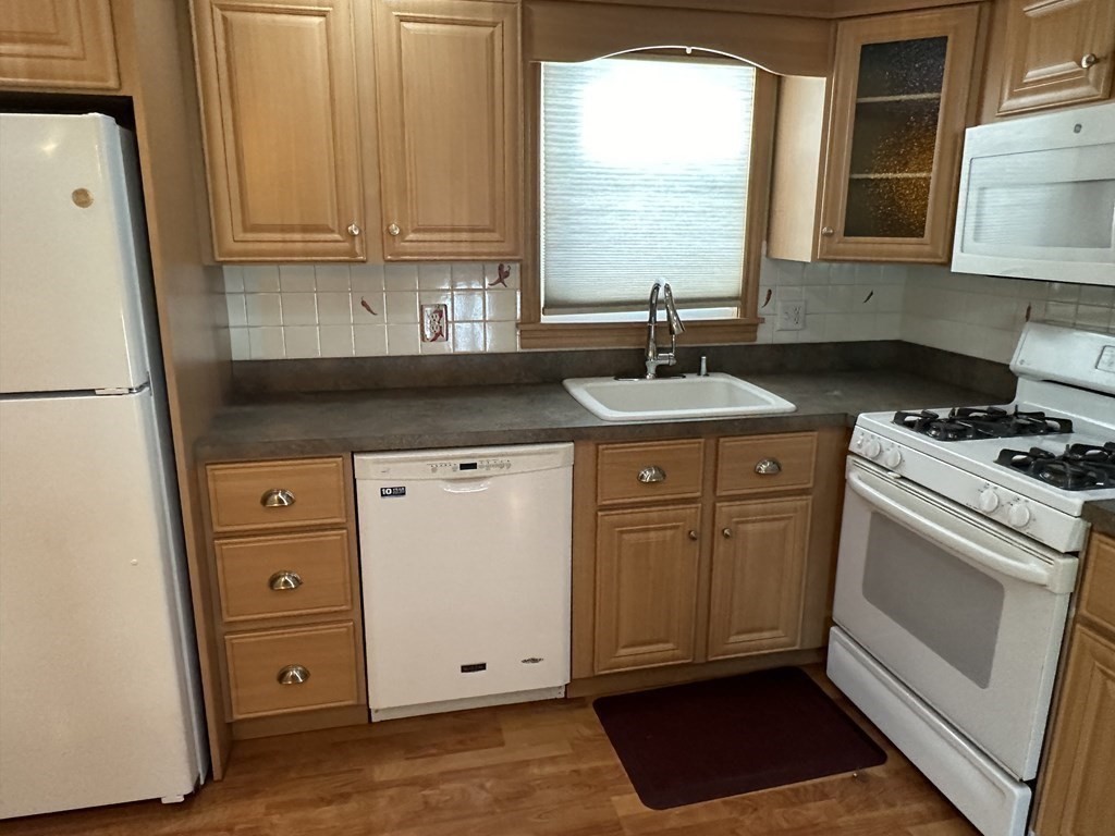 2 Monticello Circle Billerica, MA 01821 - Photo 5 of 19 a kitchen with granite countertop cabinets and white appliances
