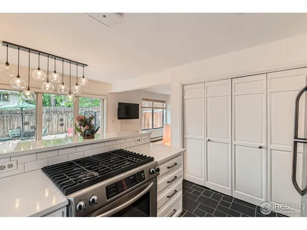 a kitchen with a white cabinets and appliances
