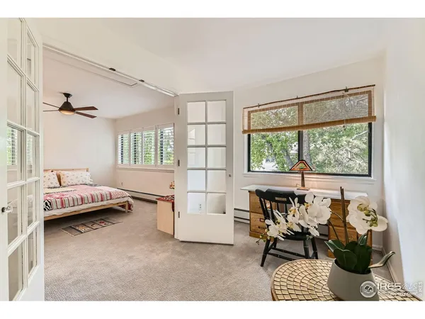 a living room with a bed and a window