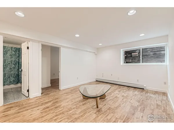 a view of wooden floor and a table in a room