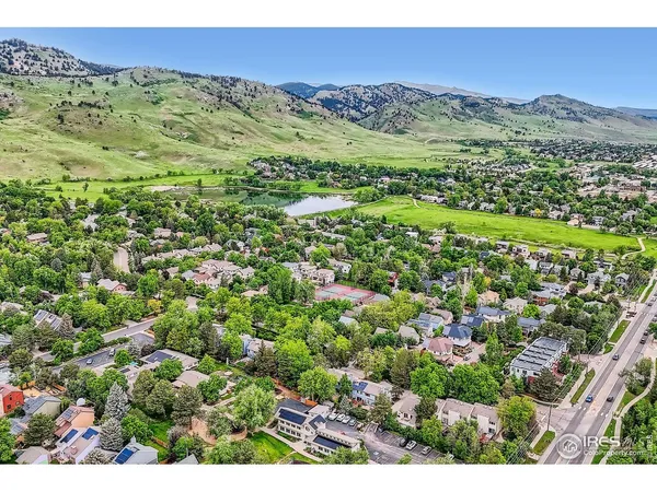 a view of a lush green hillside and houses
