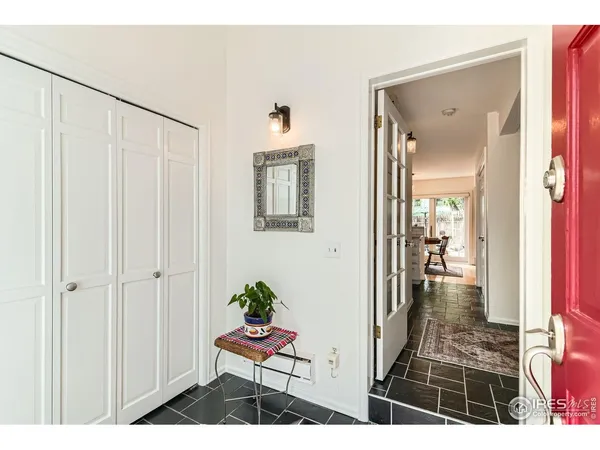 a view of a hallway with wooden floor and a livingroom view