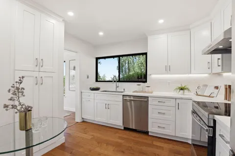 a bathroom with a granite countertop sink mirror and vanity