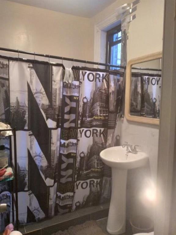 1772 Nostrand Avenue Brooklyn, NY 11226 - Photo 21 of 22 a bathroom with a sink and a mirror